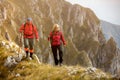 Adventure, travel, tourism, hike and people concept - smiling couple walking with backpacks outdoors Royalty Free Stock Photo