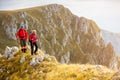 Adventure, travel, tourism, hike and people concept - smiling couple walking with backpacks outdoors Royalty Free Stock Photo