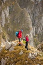 Adventure, travel, tourism, hike and people concept - smiling couple walking with backpacks outdoors Royalty Free Stock Photo