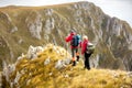 Adventure, travel, tourism, hike and people concept - smiling couple walking with backpacks outdoors Royalty Free Stock Photo