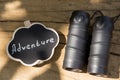 Adventure waiting for you concept small sign with Adventure inscription and binocular outdoors, wooden background