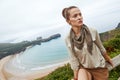 Adventure woman hiker in front of ocean view landscape