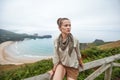 Adventure woman hiker in front of ocean view landscape