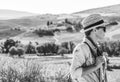 Adventure woman hiker hiking in Tuscany looking into distance