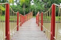 Adventure wooden rope suspension bridge crossing river