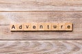 Adventure word written on wood block. adventure text on wooden table for your desing, concept