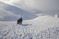 Adventurer, with backpack and snowboard in his hands