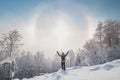 Adventurer enjoys an unusual natural phenomenon called the halo effect when the morning sun passes through frozen particles.