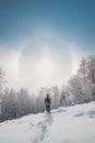 Adventurer enjoys an unusual natural phenomenon called the halo effect when the morning sun passes through frozen particles.