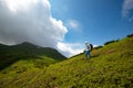 Adventurer female standing among flowering rhododendrons Royalty Free Stock Photo