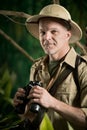 Adventurer in the jungle with binoculars Royalty Free Stock Photo