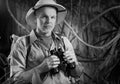 Adventurer in the jungle with binoculars Royalty Free Stock Photo