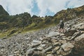 Adventurer man climbing in mountains with backpack Travel Lifestyle hiking concept summer vacations outdoor getaway Royalty Free Stock Photo