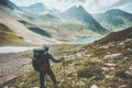 Adventurer man hiking in mountains with backpack Travel Lifestyle hiking adventure concept summer vacations outdoor exploring wild