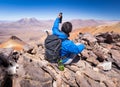 Tourist backpacker making selfie mountain peak, rear view, Bolivia Royalty Free Stock Photo