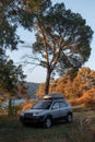 Adventures Camping tourism suv off road vehicle. Background lake, river an mountains. Landscape outdoor in morning, summer day. Royalty Free Stock Photo