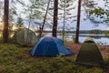 Adventures Camping tourism and tent under the view forest landscape near water outdoor in summer evening and sunset sky. Camping Royalty Free Stock Photo