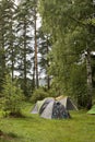 Adventures Camping tourism and tent under the view pine forest landscape near water outdoor in morning and sunset sky at Pang-ung Royalty Free Stock Photo