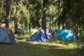 Adventures Camping tourism and tent under the view pine forest landscape near water outdoor in morning and sunset sky at Pang-ung Royalty Free Stock Photo