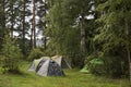 Adventures Camping tourism and tent under the view pine forest landscape near water outdoor in morning and sunset sky at Pang-ung Royalty Free Stock Photo