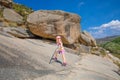 Adventuress little girl posing with trekking sticks in rocky mountain Royalty Free Stock Photo