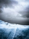 Adventuring hikers on a glacier on a cloudy day Royalty Free Stock Photo