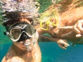 Adventurous best friends taking selfie snorkeling underwater