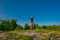 Adventurous Cyclist riding his mountain bike at the edge of a cliff, on rocky terrain while wearing no safety equipment.Amazing