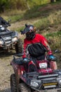 Adventurous driving of ATV motorbikes. A man drives a quad bike on dangerous roads