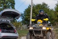 Adventurous driving of ATV motorbikes. A man drives a quad bike on dangerous roads