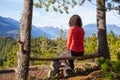 Adventurous Female Hiker is sitting on a bench and enjoying the beautiful Canadian Mountain Landscape