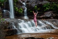 Adventurous female standing in waterfalls