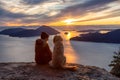 Adventurous Girl Hiking on top of a Mountain with a dog