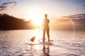 Adventurous girl on a paddle board is paddeling in the Pacific West Coast Ocean Royalty Free Stock Photo