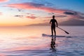 Adventurous girl on a paddle board is paddeling in the Pacific West Coast Ocean Royalty Free Stock Photo