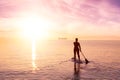 Adventurous girl on a paddle board is paddeling in the Pacific West Coast Ocean Royalty Free Stock Photo