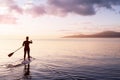 Adventurous girl on a paddle board is paddeling in the Pacific West Coast Ocean