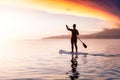 Adventurous girl on a paddle board is paddeling in the Pacific West Coast Ocean