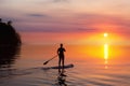 Adventurous girl on a paddle board is paddeling in the Pacific West Coast Ocean Royalty Free Stock Photo