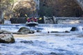 adventurous group doing white water rafting the rapids of river