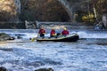 adventurous group doing white water rafting the rapids of river