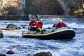 adventurous group doing white water rafting the rapids of river