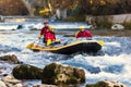 adventurous group doing white water rafting the rapids of river