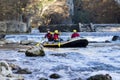 adventurous group doing white water rafting the rapids of river