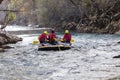 adventurous group doing white water rafting the rapids of river