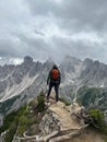 Adventurous hiker standing atop a mountain, looking out over the vast landscape below