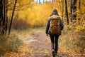 Adventurous hiker woman exploring a scenic forest hiking trail during the enchanting autumn season