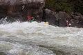 Adventurous kayaker paddling through the rough rapids on the Gauley River in West Virginia