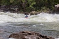 Adventurous kayaker paddling through the rough rapids on the Gauley River in West Virginia