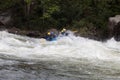 Adventurous kayakers paddling through the rough rapids on the Gauley River in West Virginia